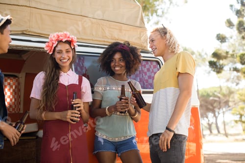 Preview: Smiling friends talking while having drink
