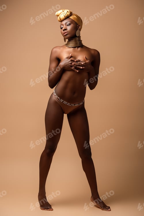 Preview: sexy naked tribal afro woman posing on beige