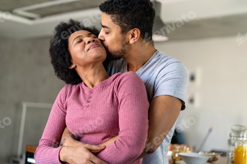Preview: Portrait of happy smiling black couple in love having fun and hugging together