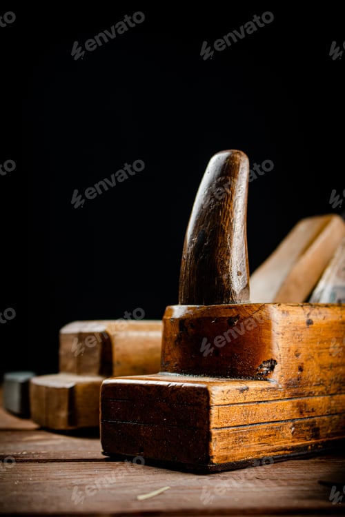 Preview: Hand planer on wood. On a black background.