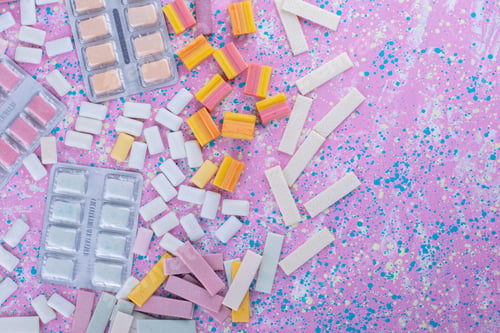 Preview: Gum tablet packs mixed in with a number of different bubble types on a colorful background