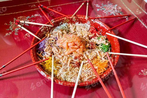 Preview: Serving of yusheng or yee sang with raw salmon belly during Chinese New Year with chop sticks laid