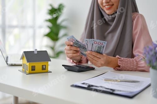 Preview: Young real estate agent counting and calculating her income and commision