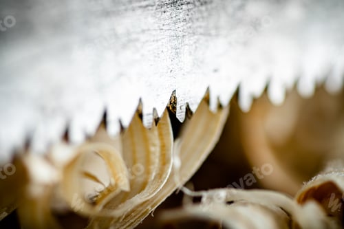 Preview: Hand saw blade on a wooden background.
