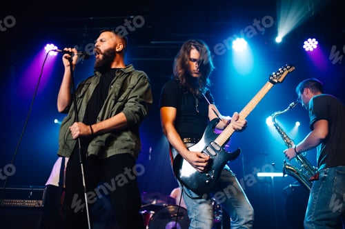 Preview: Rock band performing live on stage with singer, guitarist and saxophonist