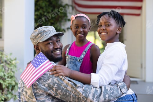 Preview: African american soldier father greeting smiling son and daughter in front of house