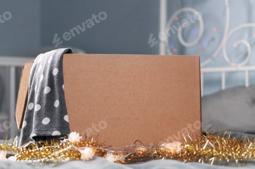 Preview: Christmas donation. Opened cardboard box mock up in bedroom with Christmas decoration