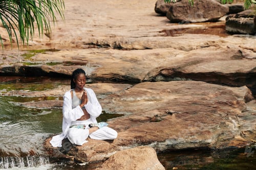 Preview: Calm beautiful woman meditating outdoors
