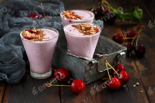 Preview: Cherry smoothie in a glass topped with fresh cherries and granola