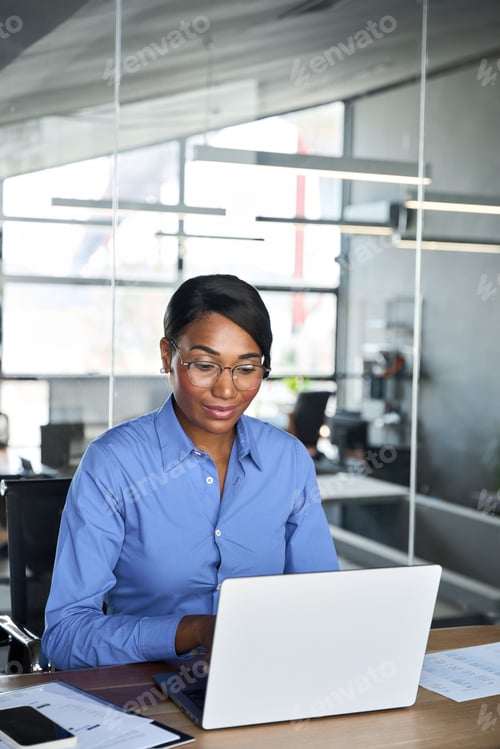 Preview: Busy professional business woman executive working on computer in office.