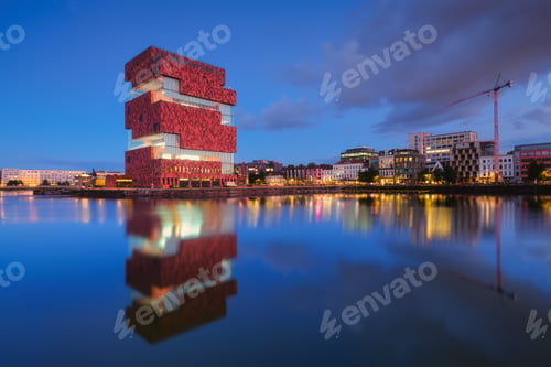 Preview: MAS museum, Antwerp, Belgium. Cityscape during sunset. Reflection on the water surface.