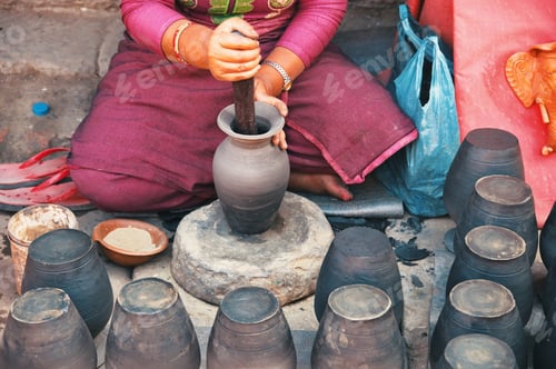 Preview: Midsection of professional potter making bowl in pottery workshop - Kathmandu