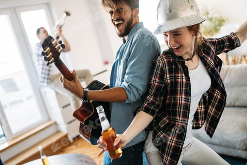 Preview: Cheerful friends having party together and playing instruments