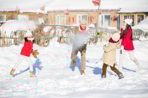 Preview: Young family having a snowball fight in the snow