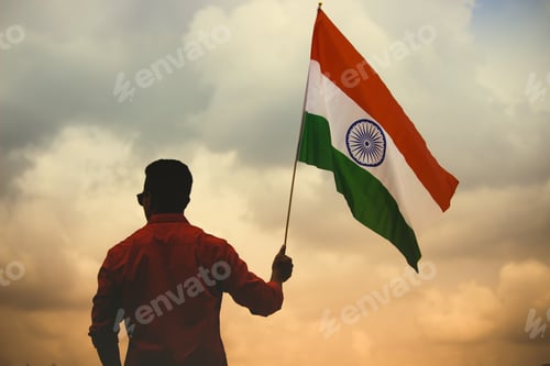 Preview: Man holding the flag of India under the evening sky