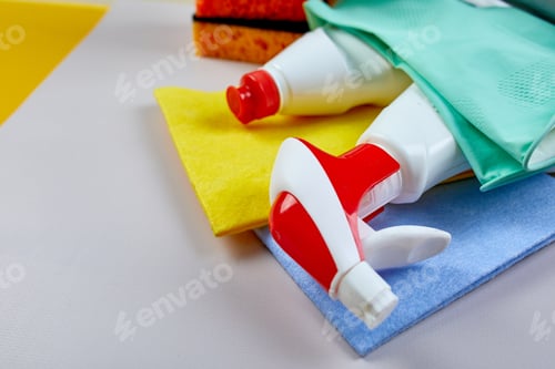 Preview: Flat lay of variety house cleaning product on grey table with copy space