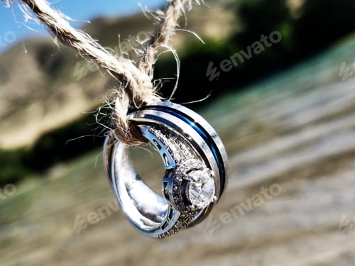 Preview: Wedding rings tied on a string symbolic tying the knot