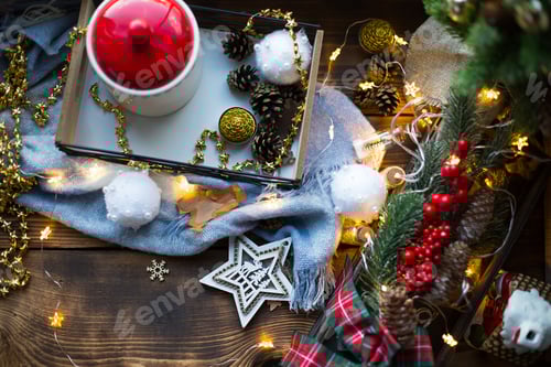 Preview: Christmas decor by the window on a cozy wooden windowsill with a mug with a drink and a cookie jar.