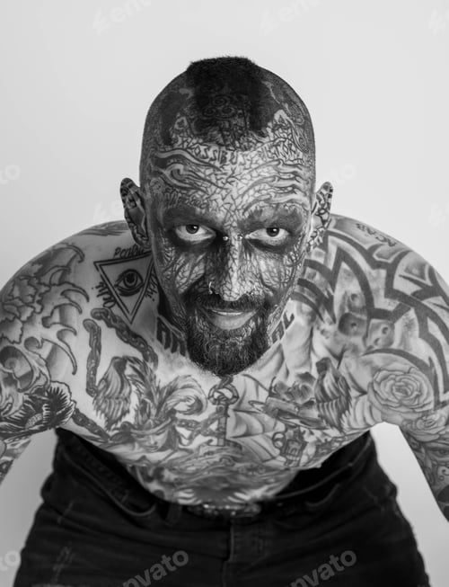 Preview: Shirtless tattooed male posing against white background