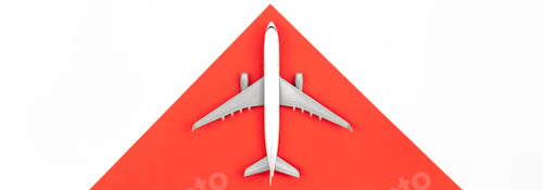 Preview: Airplane on a red and white background, flat lay, travel concept.