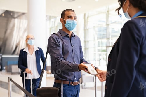 Preview: Passenger showing e-ticket at airport during covid pandemic