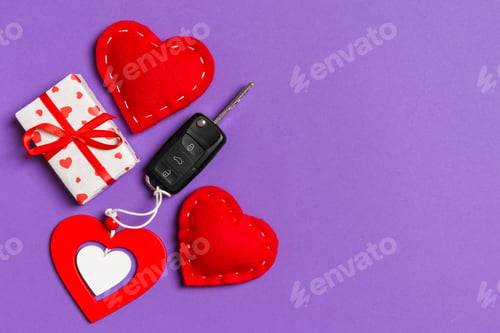 Preview: Top view of car key, gift boxes and toy hearts on colorful background. Saint Valentine's
