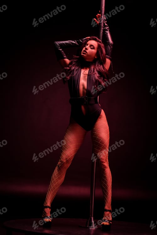 Preview: sexy young stripper dancing near pylon on black with red lighting