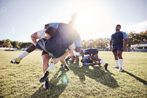 Preview: Caucasian rugby player attempting to tackle an opponent during a rugby match outside on the field.