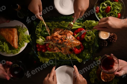 Preview: Traditional Thanksgiving dinner meal with roasted turkey and all sides dishes on wooden table.
