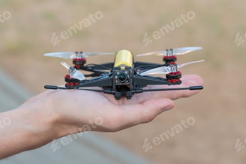 Preview: Safe quadcopter landing on the pilot's palm closeup. Man holding drone in his hand close up