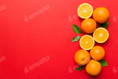 Preview: fresh Fruit orange slices on colored background. Top view. Copy Space.
