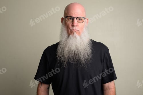 Preview: Mature bald man with long gray beard wearing eyeglasses