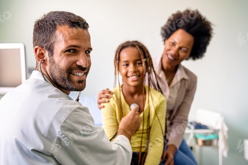 Preview: Male doctor examining a child patient in a hospital