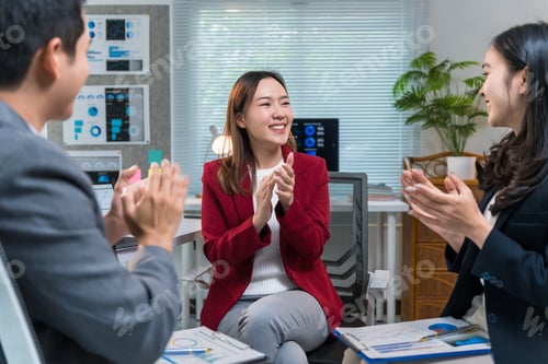 Preview: Business team applauding a colleague during a meeting