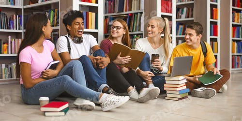 Preview: Group of teenage friends laughing while preparing for exams