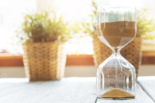 Preview: Sandglass on wooden bakground closeup. Time concept