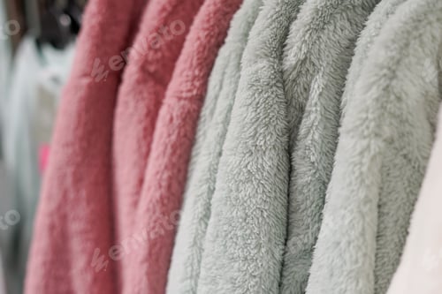 Preview: warm winter clothes on hangers closeup. Fashion concept. Winter clothes