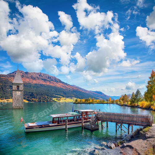 Preview: Astonishing autumn lake landscape with ship and submerged bell tower in lake Reschensee