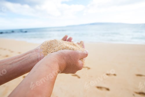 Preview: hands holding and dropping sand at a tropical ocean beach