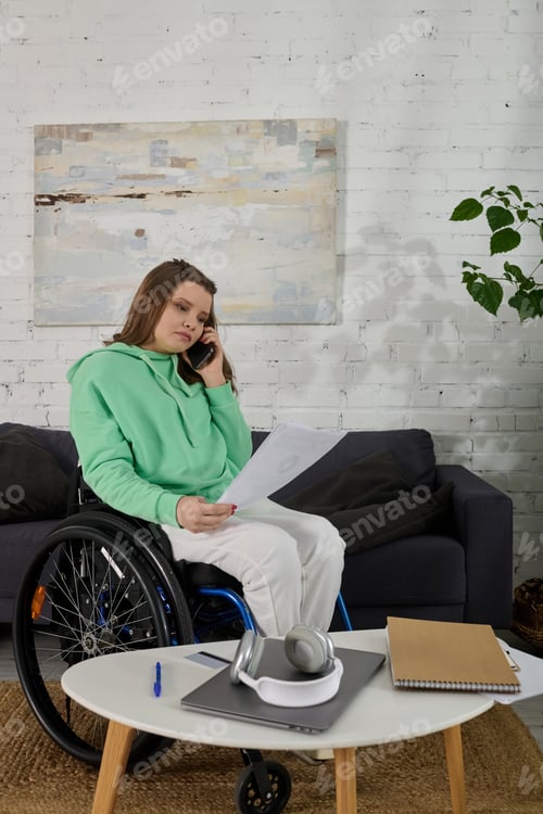 Preview: A moment of focus: young woman in wheelchair at home