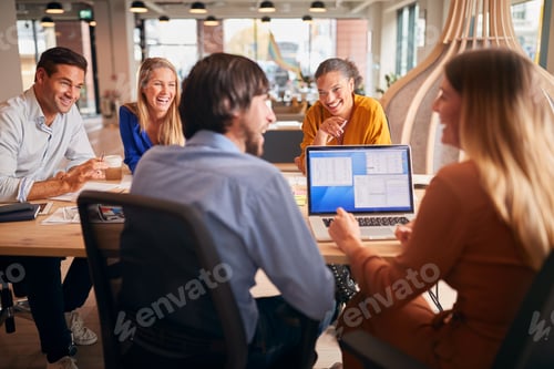Preview: Business Team Having Meeting Sitting Around Table In Modern Open Plan Office
