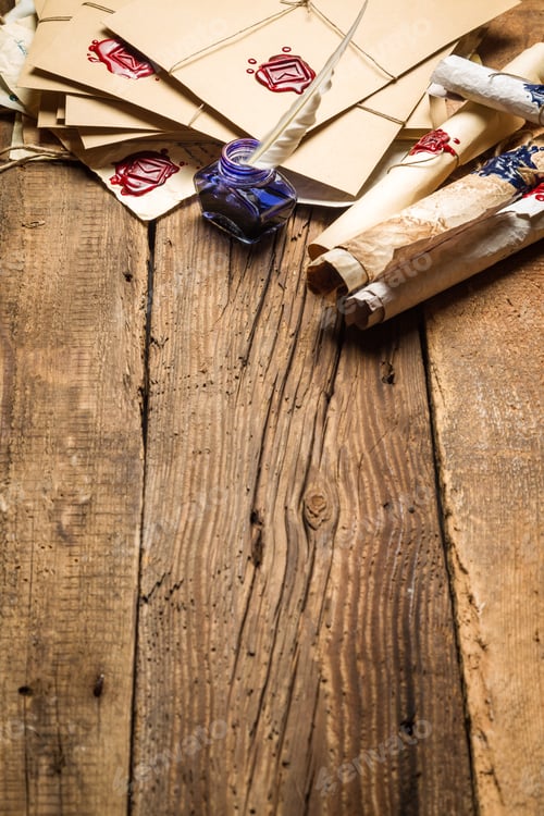 Preview: Old rolls of paper and blue ink in the inkwell as vintage background