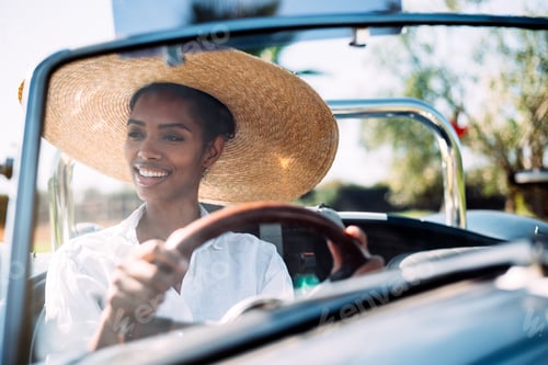 Preview: Black woman driving a vintage convertible car