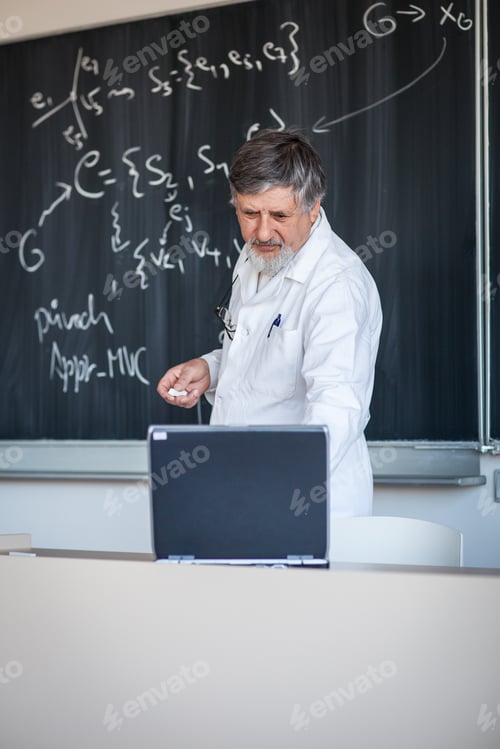 Preview: Senior chemistry professor writing on the board while having a c