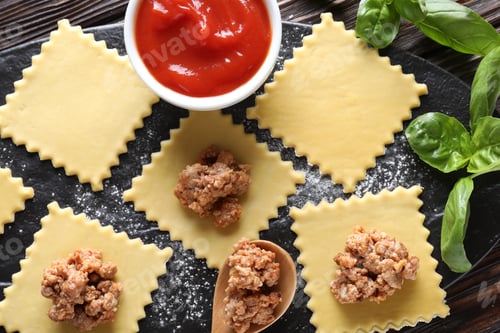 Preview: Making ravioli bolognese at wooden table, flat lay