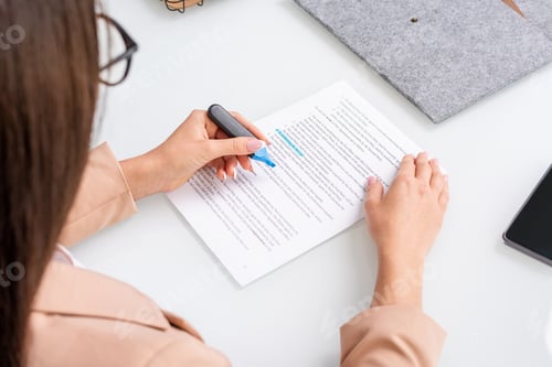 Preview: Young brunette businesswoman underlining main points and terms of contract