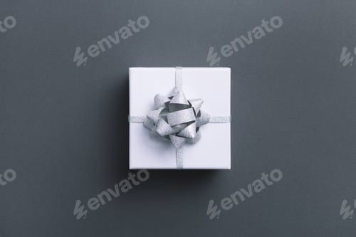 Preview: Top view of wrapped gift box on grey background.