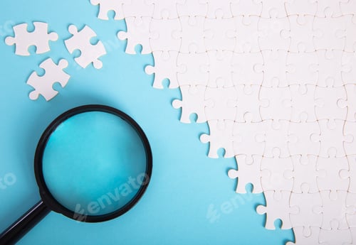Preview: Uncompleted jigsaw puzzle with magnifying glass