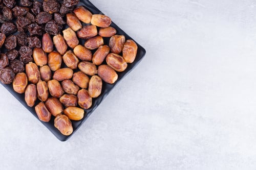 Preview: Dried cherries, berries and dates on a wooden platter