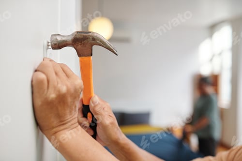 Preview: Senior Man Hammering Nails